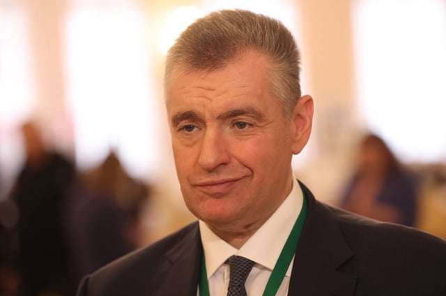 Russian lawmaker Leonid Slutsky smiles in the hallway of the Tauride Palace in Saint Petersburg on April 26, 2024.