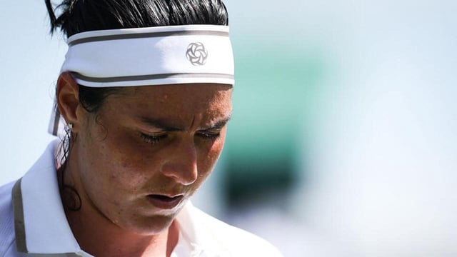Tunisia's Ons Jabeur reacts as she plays against Bulgaria's Viktoriya Tomova during their Wimbledon encounter. (AFP)