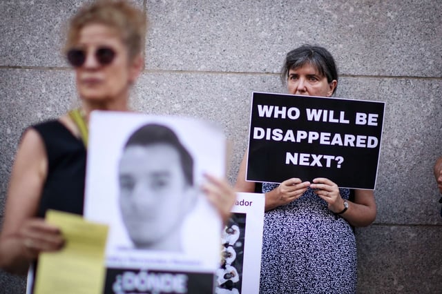 A woman holds a sign reading "Who Will Be Disappeared Next" as protesters gather outside the Permanent Mission of El Salvador to the United Nations in New York to read the names of detainees at CECOT, El Salvador's maximum-security prison, on June 5, 2025.