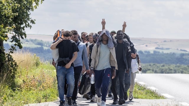 Migrants being moved from the woods behind Hardelot beach, just north of Le Touquet. The Times came across them as they were being escorted by gendarmes towards Boulogne