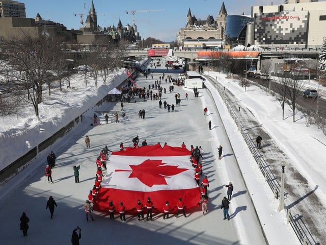 A Canadian flag is skated along the Rideau Canal in Ottawa during the celebrations of National Flag of Canada Day, February 14, 2025.
