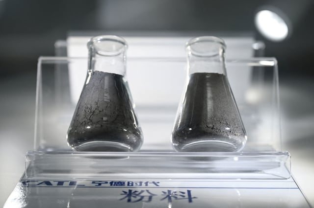 Graphite powder, left, and powder made from nickel, copper and magnesium, right, which are used to make lithium-ion batteries, are displayed in the showroom of Chinese EV battery maker CATL. The United States just imposed an additional 93.5% tariffs on graphite imports from China, which could significantly raise the cost of building electric vehicles at American plants.