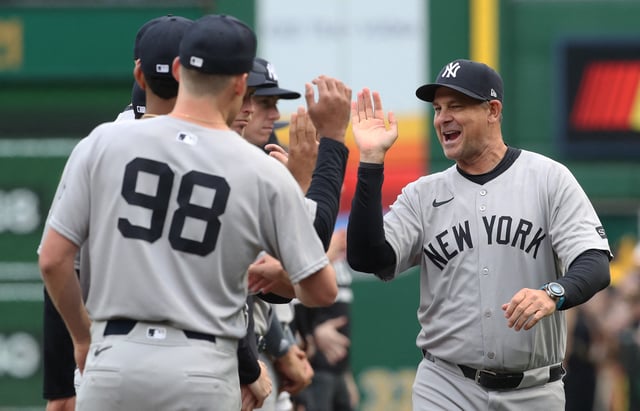 Apr 4, 2025; Pittsburgh, Pennsylvania, USA; New York Yankees manager Aaron Boone (17) greets his team during player introductions against the Pittsburgh Pirates n the 2025 Opening Day game at PNC Park. Mandatory Credit: Charles LeClaire-Imagn Images/File Photo