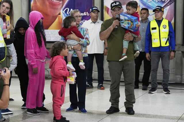 Venezuela's Interior Minister Diosdado Cabello, right, and First Lady Cilia Flores welcome children of Venezuelan migrants, whose parents were deported separately from the United States, at Simon Bolivar International Airport in Maiquetia, Venezuela, Friday, July 18, 2025. (AP Photo/Ariana Cubillos)