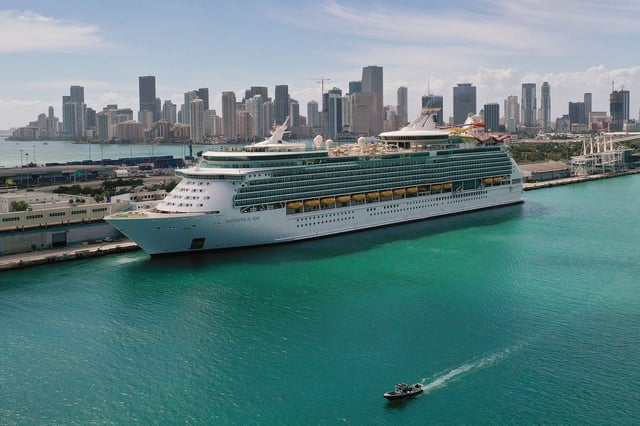 MIAMI, FLORIDA - MARCH 02: An aerial view from a drone shows Royal Caribbean’s Navigator of the Sea cruise ship docked at PortMiami on March 02, 2021 in Miami, Florida. Royal Caribbean Group announced plans to use the proceeds from a $1.5 billion sale of shares to pay off debt stemming from the pandemic. (Photo by Joe Raedle/Getty Images)