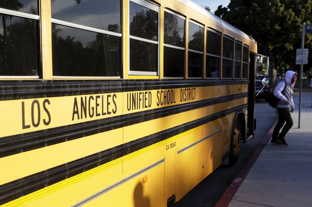 A student exits a bus as he arrives at Venice High School in Los Angeles, California December 16, 2015.  REUTERS/Jonathan Alcorn/File Photo