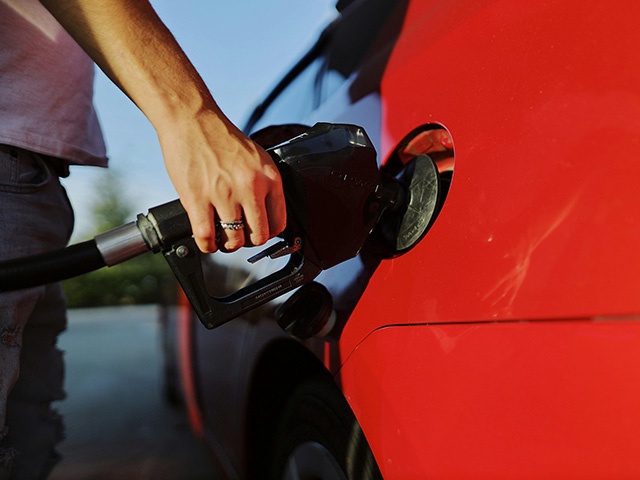 Filling Up a Red Car with Gas