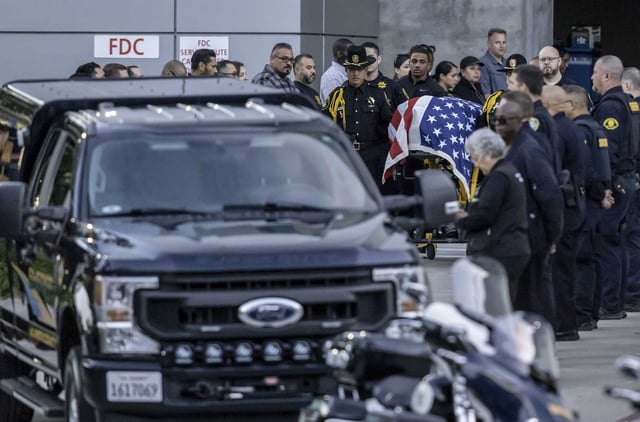 Police officers from several agencies pay their respects Thursday at Highland Hospital in Oakland after a state parole agent was shot and killed earlier in the day.