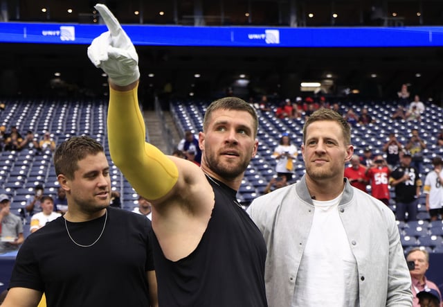 Former Pittsburgh Steelers player Derek Watt, T.J. Watt #90 of the Pittsburgh Steelers, and Houston Texans player J.J. Watt look on prior to a game between the Pittsburgh Steelers and the Houston Texans at NRG Stadium on October 01, 2023 in Houston, Texas.
