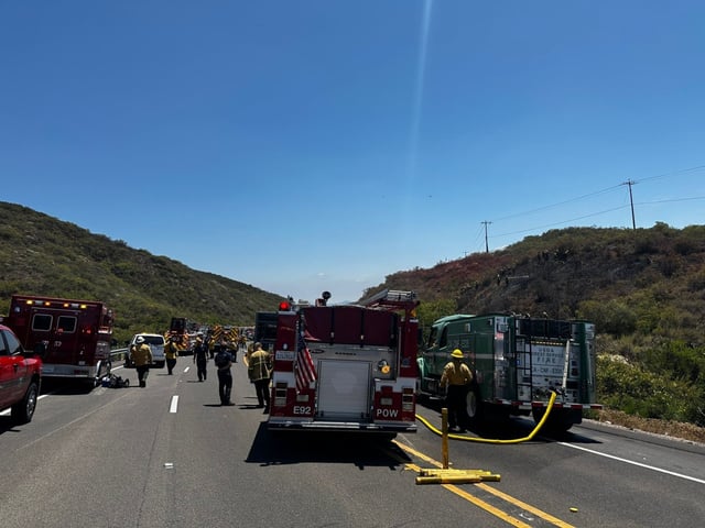 Emergency crews respond to a fatal crash that sparked a brush fire off state Route 67 in Poway on Friday. (Cal Fire)