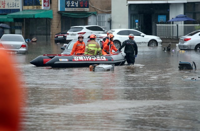 Firefighters take part in a rescue operation at a flooded area caused by torrential rain in Daegu, South Korea, July 17, 2025. Yonhap via REUTERS/File Photo