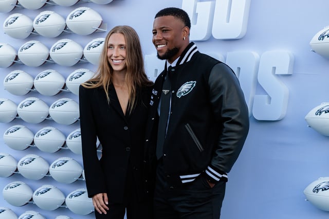 Anna Congdon and Saquon Barkley #26 of the Philadelphia Eagles pose for photographs on the Green Carpet during the Philadelphia Eagles Super Bowl ring ceremony at The Battery on July 18, 2025 in Philadelphia, Pennsylvania.