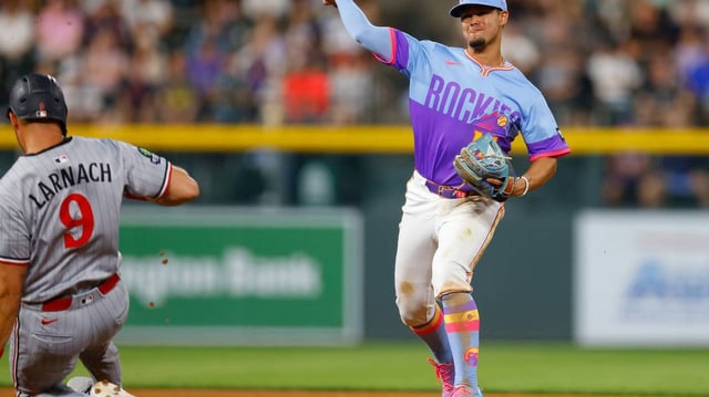 Colorado Rockies shortstop Ezequiel Tovar throws to first base to complete the double play as the Minnesota Twins’ Trevor Larnach (9) slides in in the eighth inning at Coors Field on Friday, July 18, 2025, in Denver. (Justin Edmonds/Getty Images/TNS)