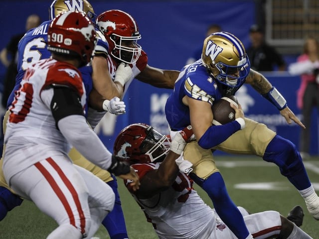  Blue Bombers quarterback Chris Streveler is sacked by Stampeders defensive lineman Jaylon Hutchings on Friday.