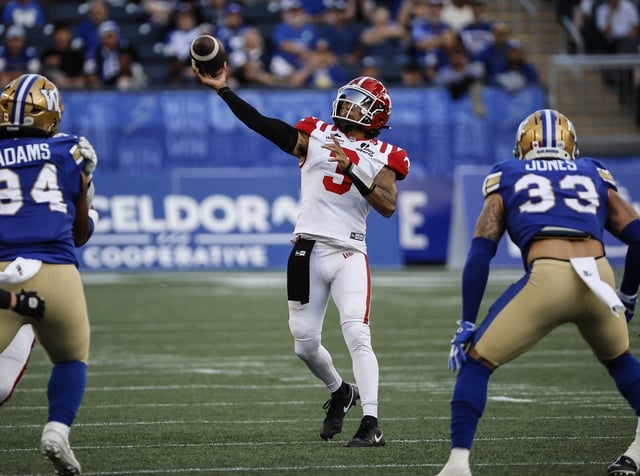 Calgary Stampeders quarterback Vernon Adams Jr. (3) throws a touchdown pass to Damien Alford (not shown) during first half CFL action against the Winnipeg Blue Bombers in Winnipeg Friday, July 18, 2025.