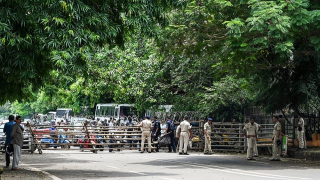 Police personnel block a road leading to the Odisha Assembly in view of the protest march of BJD workers over the death of a college student in Odisha's Balasore