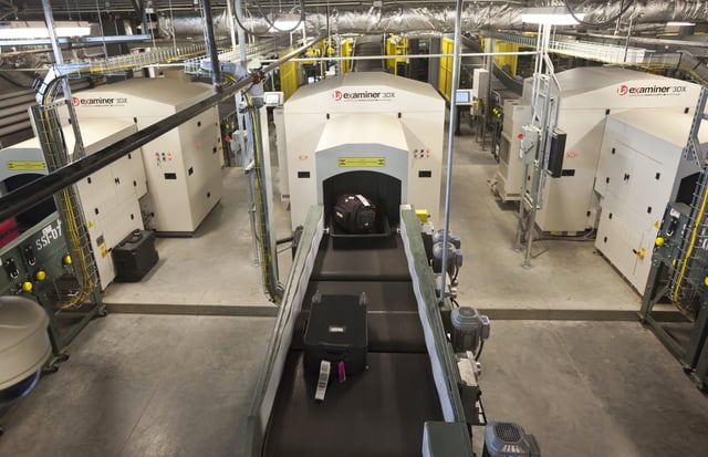 FILE - Air travelers' bags ride a conveyor into one of three new advanced in-line screening machines at Bill and Hillary Clinton National Airport in Little Rock, Ark., Oct. 16 2012. (AP Photo/Danny Johnston, File)