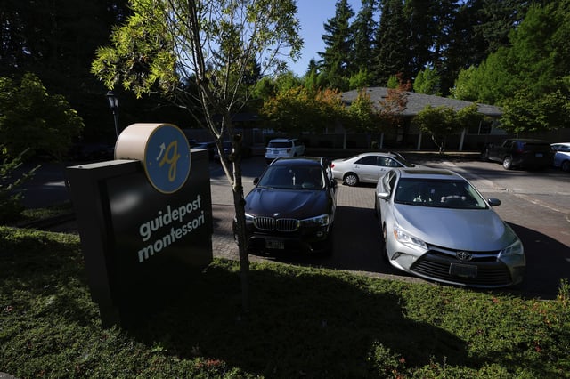 Children are dropped off at the Guidepost Montessori school on Friday, July 18, 2025, in Beaverton, Ore. (AP Photo/Jenny Kane)