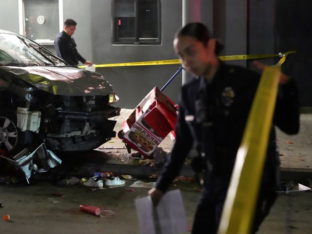 Law enforcement investigate the scene where a vehicle rammed into a crowd of people waiting to enter a nightclub along a busy boulevard in Los Angeles early Saturday, July 19, 2025 injuring several people. (AP Photo/Damian Dovarganes)