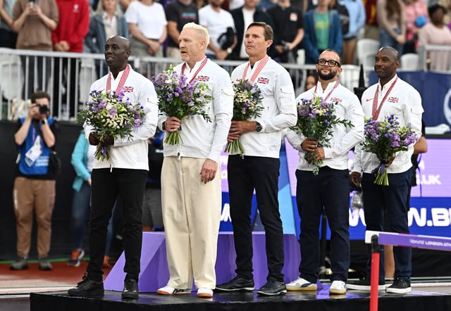 Athletics - Diamond League - London - London Stadium, London, Britain - July 19, 2025 Following the disqualification of the US men's 4x400m at the 1997 World Championships in Athens, Britain's Mark Hylton, Iwan Thomas, Roger Black, Jamie Baulch and Mark Richardson stand on the podium after receiving their Gold medals REUTERS/Dylan Martinez