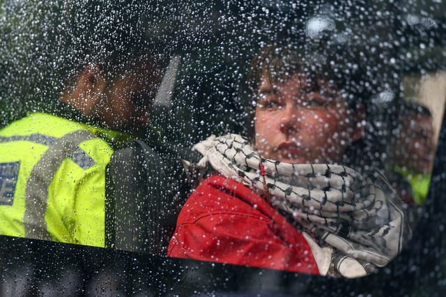 A detained demonstrator sits inside a police van, following a protest in support of the Palestine Action group in Parliament Square in London, Britain, July 19, 2025. REUTERS/Isabel Infantes