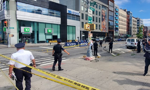 Police investigate after two people were killed when an out-of-control car drove onto the sidewalk on Canal St. and Bowery on Saturday morning. (Theodore Parisienne / New York Daily News)