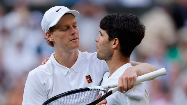 Italy's Jannik Sinner reacts with Spain's Carlos Alcaraz after winning the Wimbledon men's final.
