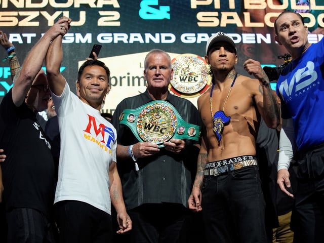 Manny Pacquiao, left, and WBC welterweight champion Mario Barrios pose at a ceremonial weigh in Friday, July 18, 2025, in Las Vegas. (AP Photo/John Locher)