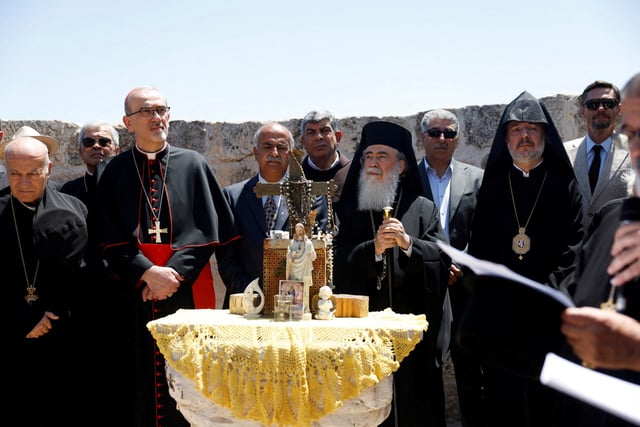 Latin Patriarch in Jerusalem, Pierbattista Pizzaballa, and Greek Orthodox patriarch of Jerusalem, Theophilos III, look on during the visit to the town of Taybeh, a Christian village in the Israeli-occupied West Bank, following settler attacks, July 14, 2025. REUTERS/Mohammed Torokman/File Photo