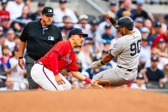ATLANTA, GA - JULY 18: Nacho Alvarez Jr. #17 of the Atlanta Braves tags out Jorbit Vivas #90 of the New York Yankees in the third inning during the game between the Atlanta Braves and the New York Yankees at Truist Park on July 18, 2025 in Atlanta, Georgia.