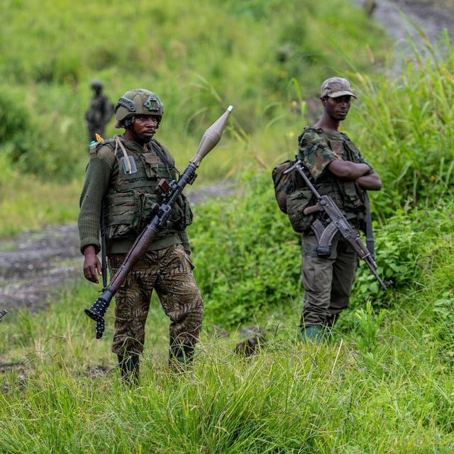 FILE - M23 rebels stand with their weapons in Kibumba, in the eastern of Democratic Republic of Congo, Dec. 23, 2022. (AP Photo/Moses Sawasawa, File)