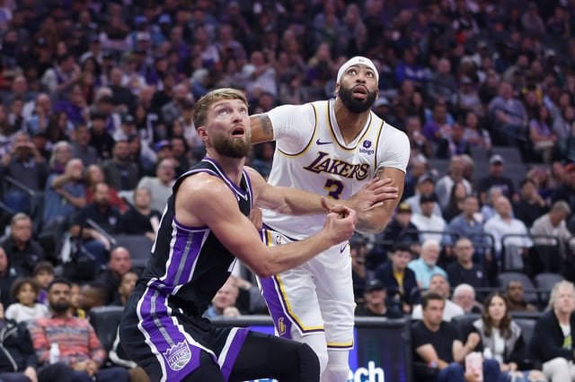 Domantas Sabonis #10 of the Sacramento Kings competes for a rebound against Anthony Davis #3 of the Los Angeles Lakers in the first quarter at Golden 1 Center on October 29, 2023 in Sacramento, California.