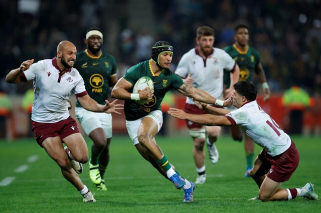 South Africa winger Edwill van der Merwe (C) bursts past Georgia defenders in Mbombela.