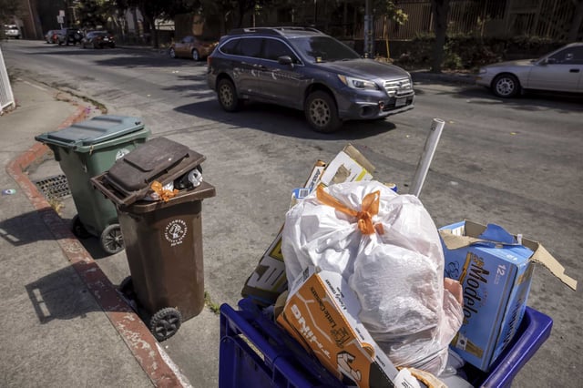 Unemptied trash bins line Brookside Drive in Richmond on Tuesday before the Teamsters reached a tentative pact with Republic Services.