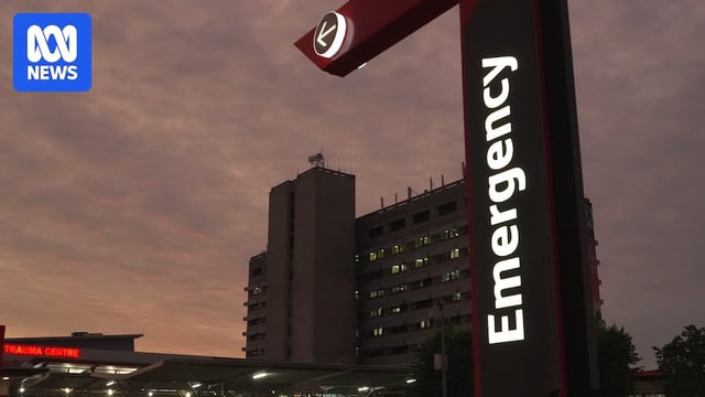 Emergency hospital sing with hospital building in background 