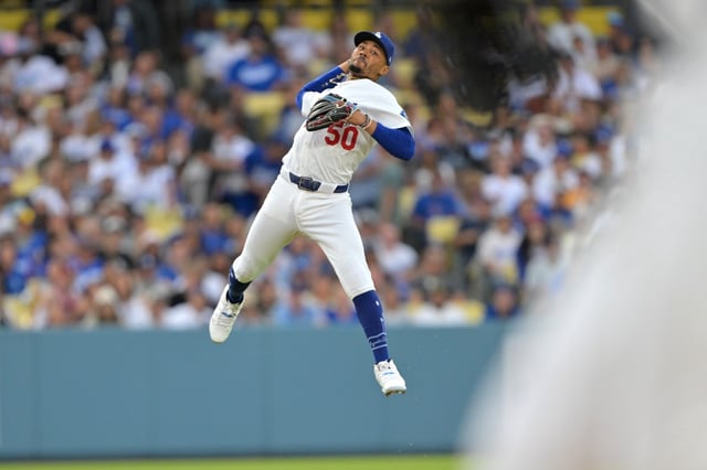 Dodgers shortstop Mookie Betts makes a leaping throw but is unable to force out the Milwaukee Brewers’ Isaac Collins at first base during the second inning on Friday, July 18, 2025, at Dodger Stadium. (Photo by Jayne Kamin-Oncea/Getty Images)