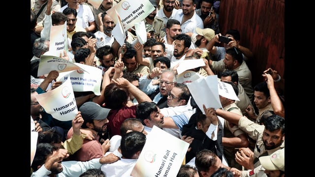 JKPCC chief Tariq Hameed Karra and supporters during a protest in demand of the restoration of statehood, in Srinagar, on Saturday. (ANI)