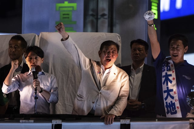 Japan's Prime Minister and Liberal Democratic Party President Shigeru Ishiba, center, attends an election campaign event in support of his party's candidates on the eve of the July 20 Upper House election, in Tokyo, Saturday, July 19, 2025. (AP Photo/Louise Delmotte)
