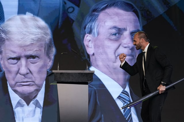 Eduardo Bolsonaro, the son of Brazil's former President Jair Bolsonaro, takes the stage backdropped by a screen featuring U.S. President Donald Trump, and Jair Bolsonaro, at the Conservative Political Action Conference in Buenos Aires, Argentina, Dec. 4, 2024. (AP Photo/Natacha Pisarenko, File)