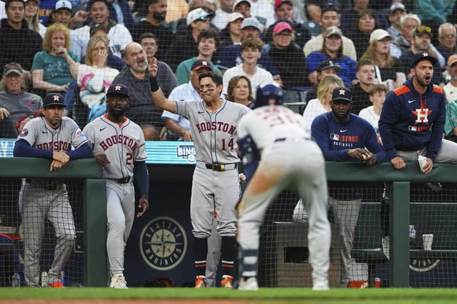 The Houston Astros dugout, including Mauricio Dubón (14) react after Zack Short, front, was hit by a pitch from Seattle Mariners relief pitcher Carlos Vargas during the sixth inning of a baseball game Saturday, July 19, 2025, in Seattle. (AP Photo/Lindsey Wasson)