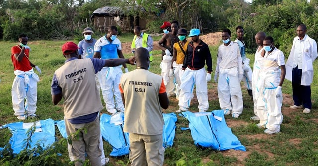 Forensic experts and homicide detectives from the Directorate of Criminal Investigations (DCI), sort exhumed bodies of suspected followers of a Christian cult named Good News International Church, who believed that they would go to heaven if they starved themselves to death, in Shakahola forest of Kilifi county, Kenya May 11, 2023. REUTERS/Stringer
