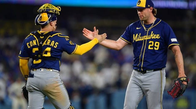 Jul 19, 2025; Los Angeles, California, USA; Milwaukee Brewers pitcher Trevor Megill (29) and catcher William Contreras (24) celebrate the victory against the Los Angeles Dodgers at Dodger Stadium. Mandatory Credit: Gary A. Vasquez-Imagn Images