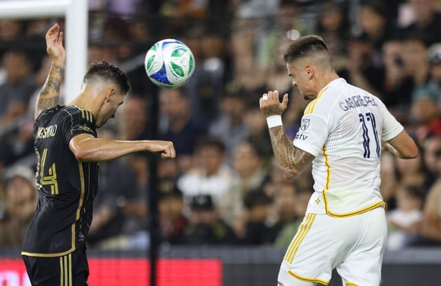 LOS ANGELES, CALIFORNIA – JULY 19: Gabriel Pec #11 of the Galaxy and Ryan Hollingshead #24 of the LAFC vie for the ball during the first half of their derby against the Los Angeles Football Club at BMO Stadium on July 19, 2025 in Los Angeles, California. (Photo by Luiza Moraes/Getty Images)