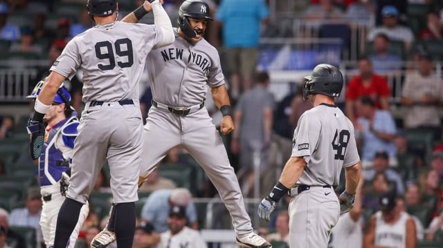 Jul 19, 2025; Atlanta, Georgia, USA; New York Yankees center fielder Trent Grisham (12) celebrates with right fielder Aaron Judge (99) after a grand slam against the Atlanta Braves in the ninth inning at Truist Park. Mandatory Credit: Brett Davis-Imagn Images