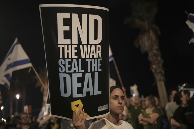 People take part in a protest outside US Embassy Branch demanding the end of the war and immediate release of hostages held by Hamas in the Gaza Strip, and against Prime Minister Benjamin Netanyahu's government in Tel Aviv, Israel, Saturday, July 19, 2025. (AP Photo/Maya Alleruzzo)