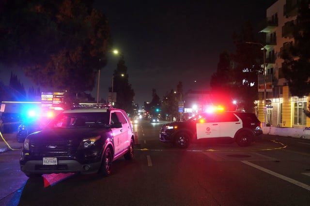 Police patrol vehicles close Vermont Ave. after a vehicle rammed into a crowd gathered outside "The Vermont" nightclub in Los Angeles, early Saturday.
