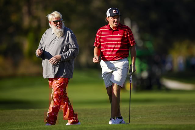 John Daly and his son John Daly II look over a putt on the 18th hole during the first round of the PNC Championship at Ritz-Carlton Golf Club on December 21, 2024 in Orlando, Florida.