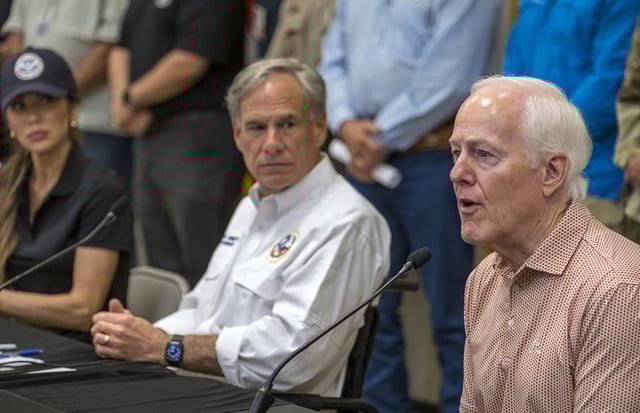 Sen. John Cornyn, right, speaks to media during a press conference as Homeland Security Secretary Kristi Noem, left, and Gov. Greg Abbott, center, listen after recent flooding along the Guadalupe River during a press conference on Saturday, July 5, 2025, in Kerrville, Texas. (AP Photo/Rodolfo Gonzalez)