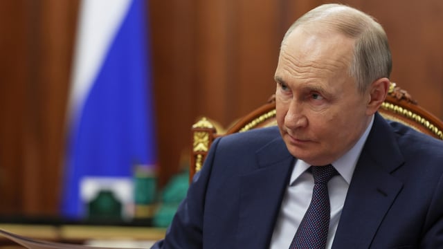 Russian President Vladimir Putin speaks with Alexander Avdeyev, the governor of Vladimir region, during their meeting at the Kremlin in Moscow
