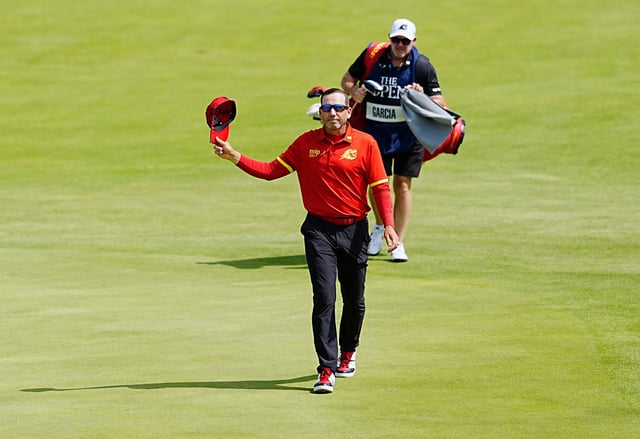 Spain's Sergio García waves to the crowd as he walks the fairway at the 18th hole.